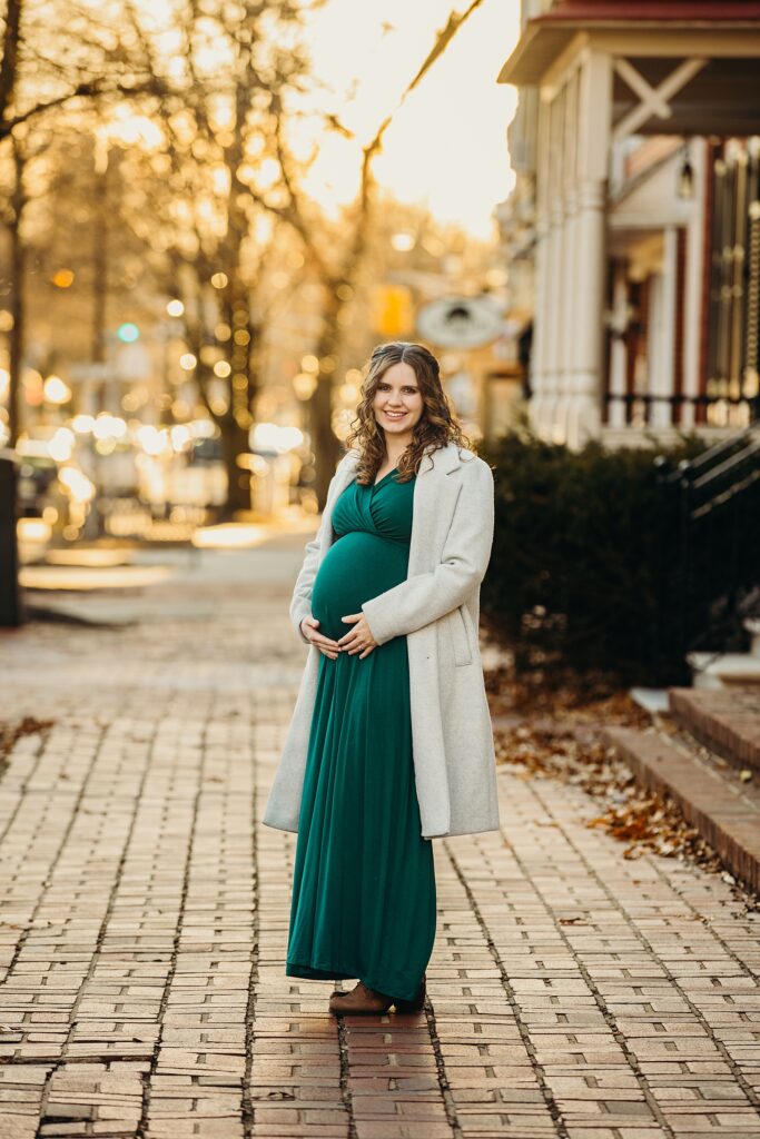 A woman during her winter maternity photoshoot in society hill, Pennsylvania 