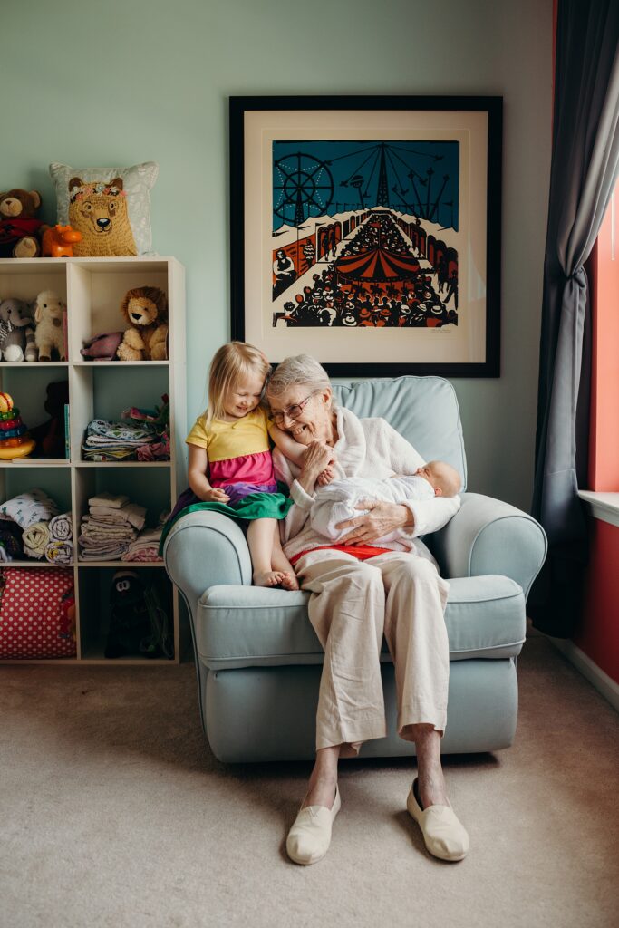 2 young girls with their grandmother during a lifestyle newborn session in Philadelphia 