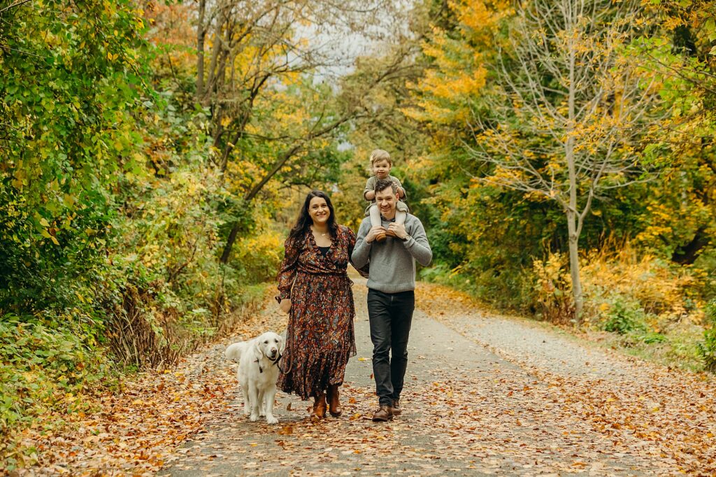 fall family photoshoot with a dog walking on a park trail in Wayne, PA 