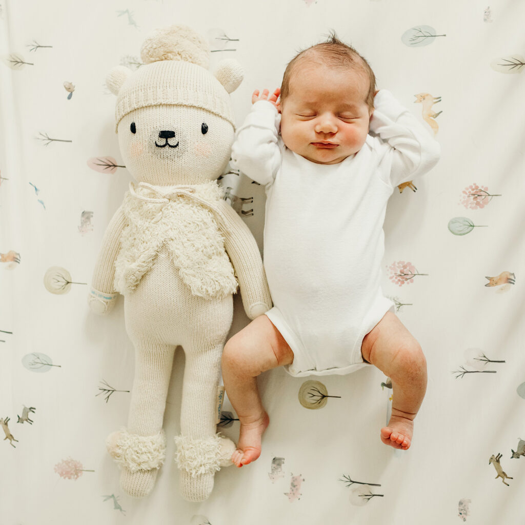 newborn size compared to stuffed animal during lifestyle newborn photos