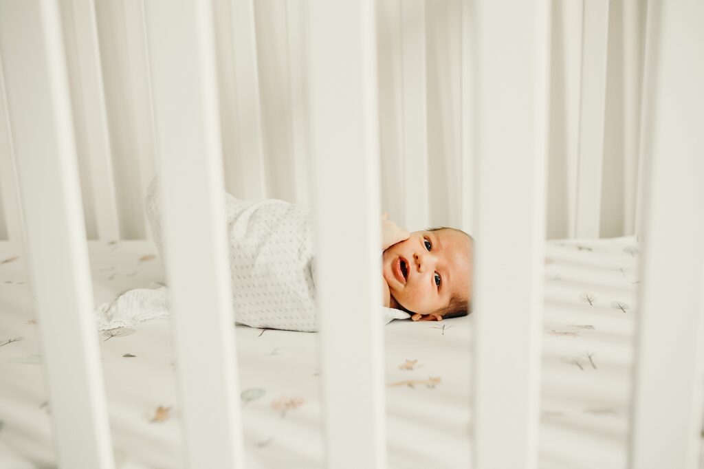 newborn girl in her crib during her lifestyle Pennsylvania newborn photoshoot