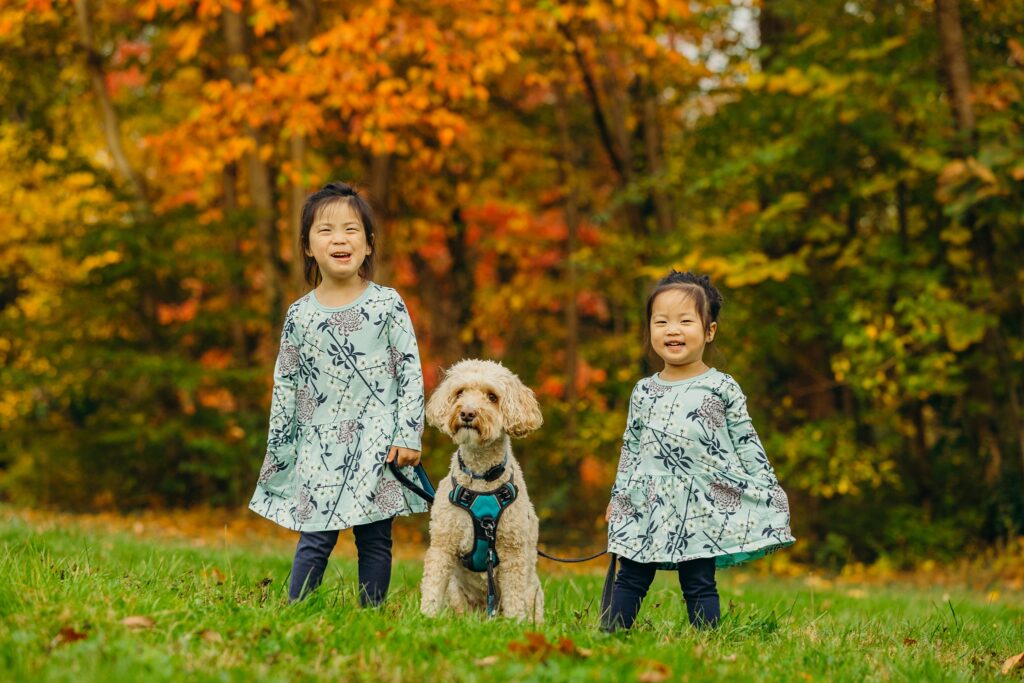 two young girls with their pet dog during their Fall family photos in Philadelphia