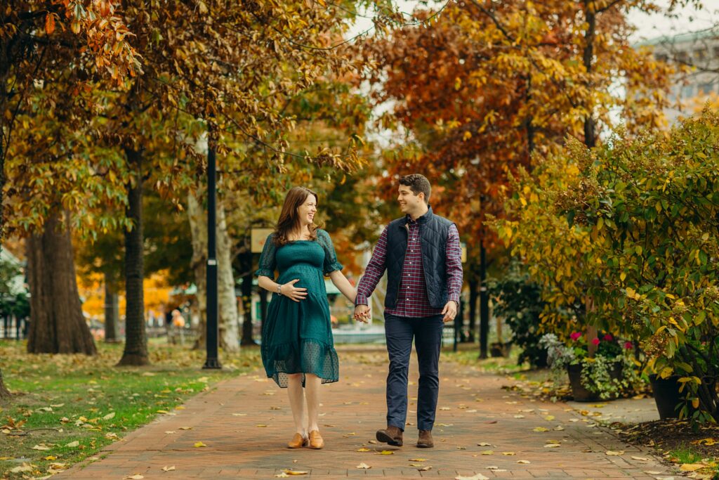 a couple walking through Old City Philadelphia during their Lifestyle Fall Maternity photoshoot 