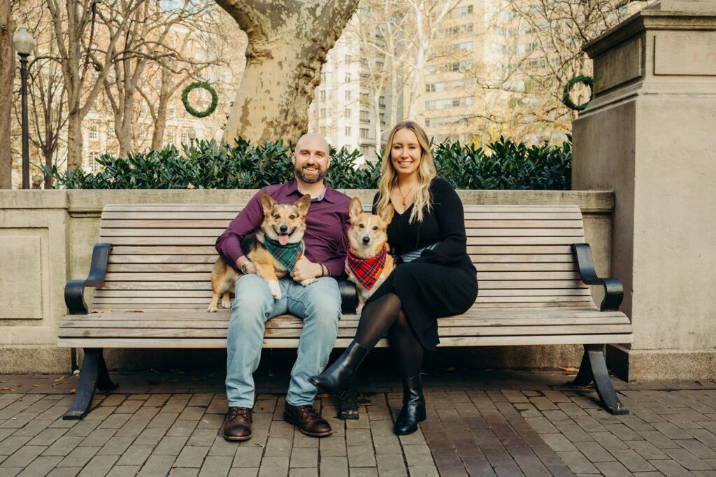 a Philadelphia couple with their 2 corgis in Old City Philadelphia at Rittenhouse Park during a pet photoshoot 