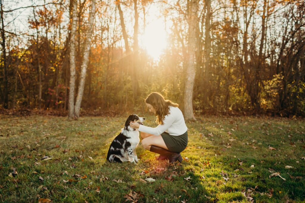 a mini australian shepherd with her owner during holiday pet photo session at a park in Lansdale, PA 