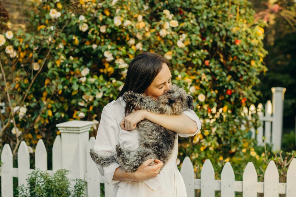 a woman and her dog during a spring pet photo session in Chestnut Hill in Philadelphia 