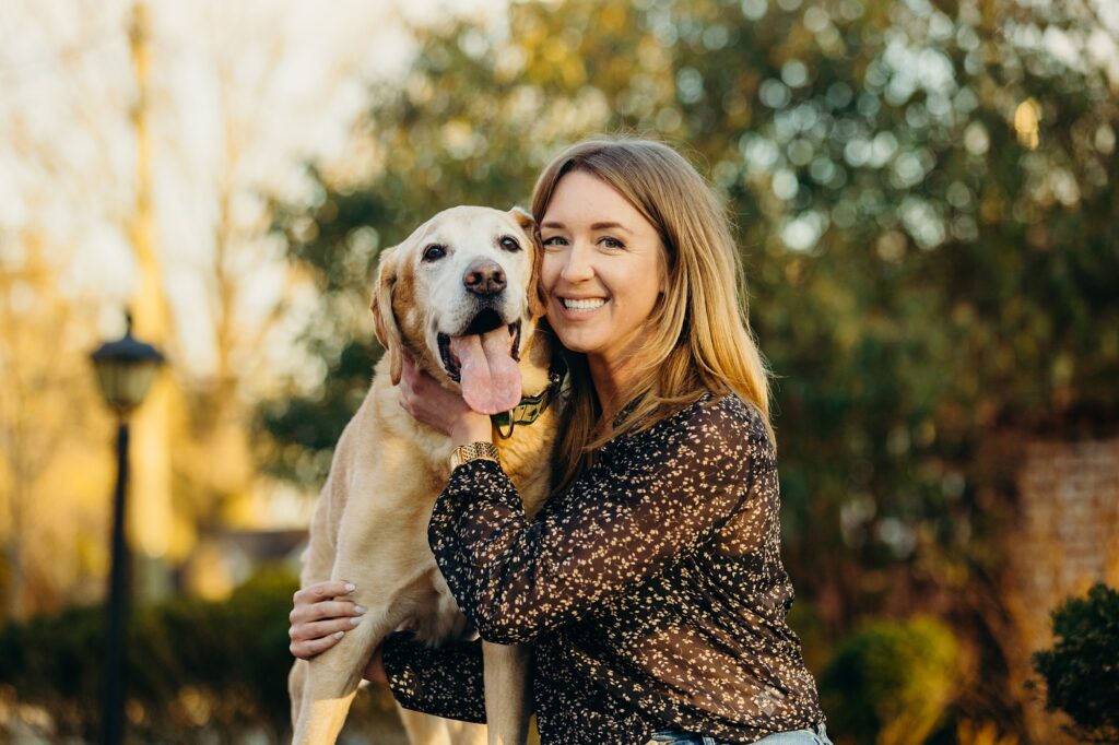 a woman and her older golden lab in a lifestyle pet session in the winter in New Jersey 