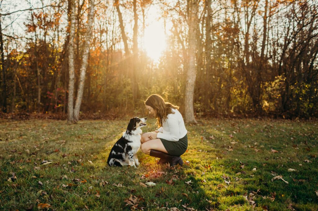 a girl and her Australian shepherd puppy during a fall pet photoshoot in Montgomery County, PA. 