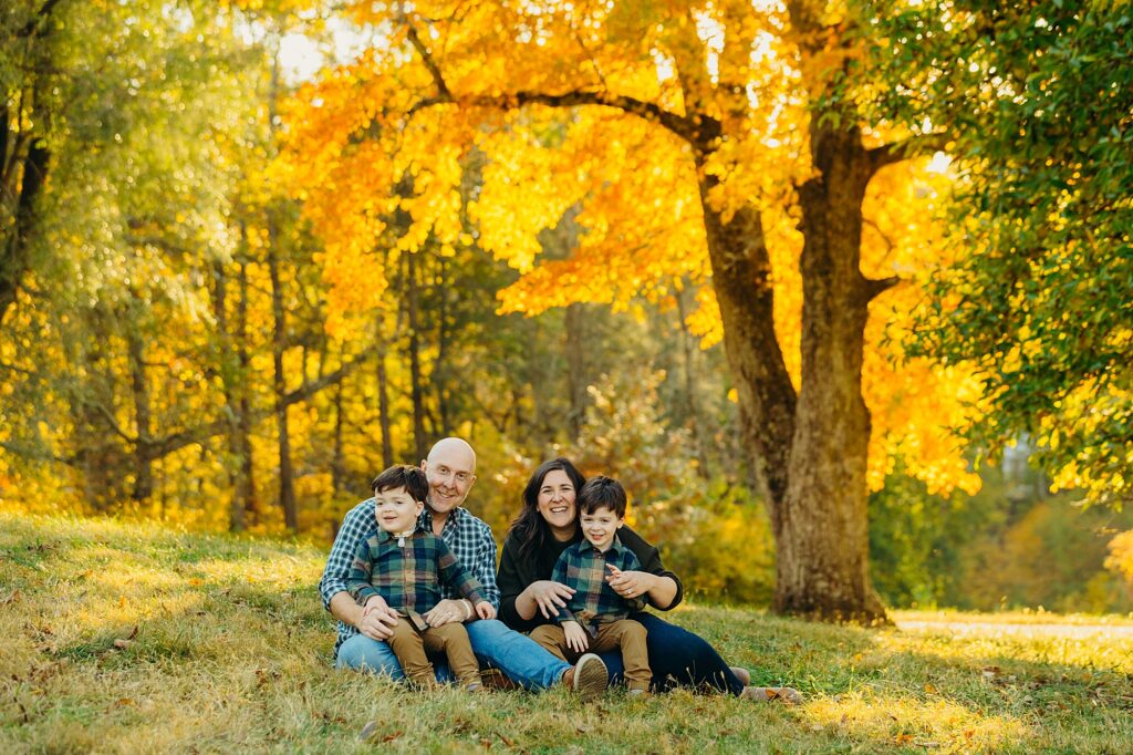 A family with twin boys photo during the fall season in Valley Forge during a family photoshoot. 
