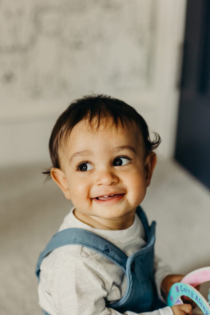 portrait of baby boy smiling during a lifestyle family session 