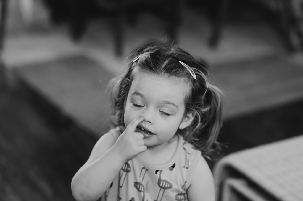 a funny toddler during her at home lifestyle family photoshoot in Center City Philly. 