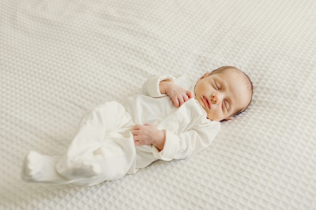 a sleepy newborn boy during his lifestyle at home newborn session in South Philadelphia. 
