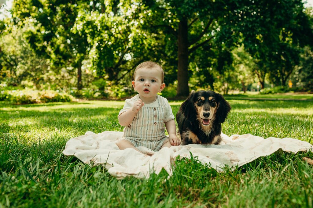 baby boy and his pet dog during an outdoor summer lifestyle family photo session in Center City, Philadelphia